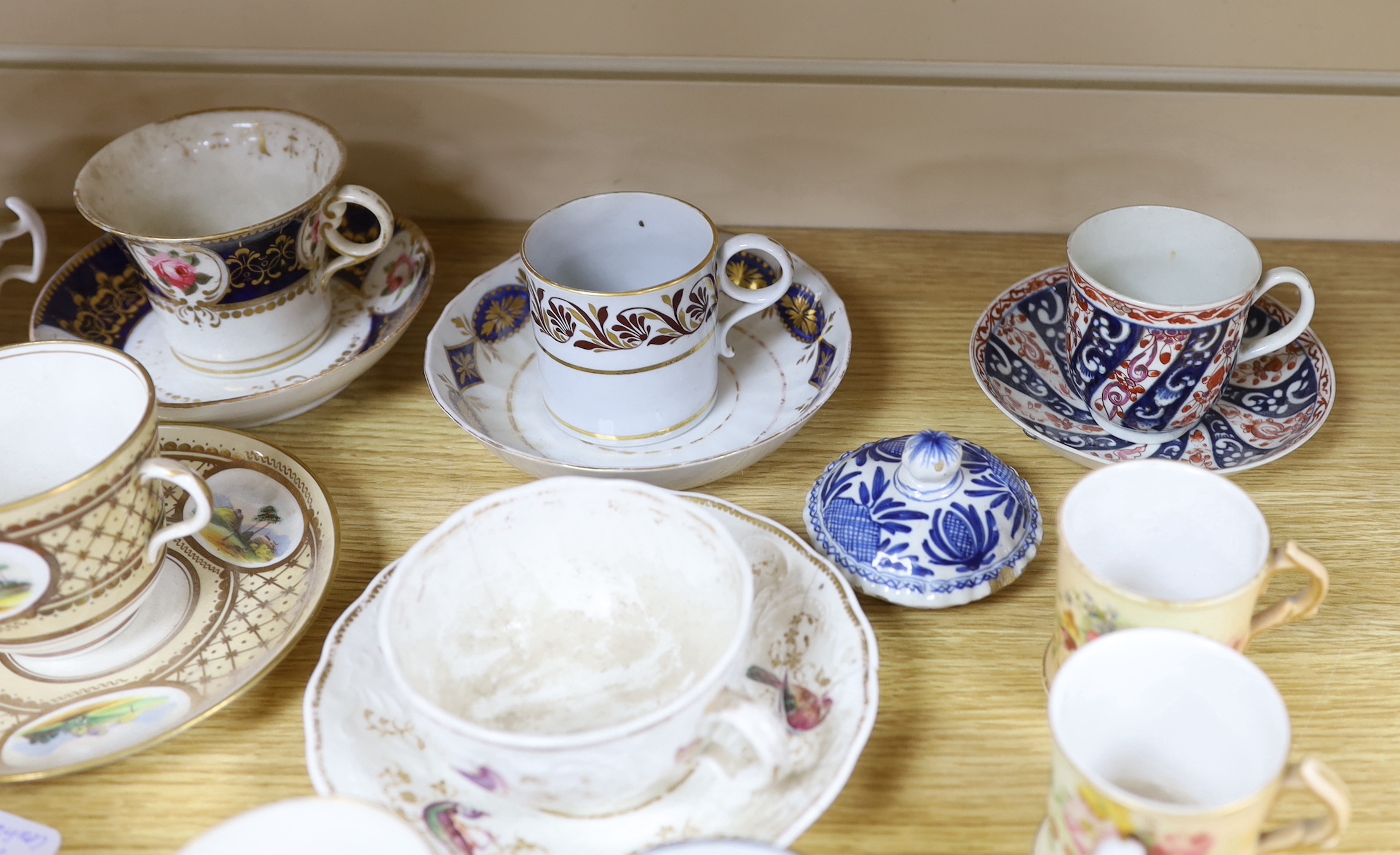 A collection of 18th and 19th century English and continental tea and coffee cups some with saucers, including a Worcester Queen Charlotte pattern coffee cup and saucer